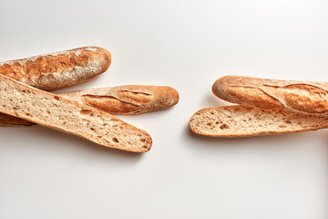 Fresh cut baguettes on a gray background with copy space. Healthy food. Flat lay