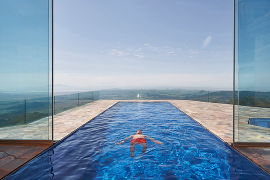 Man floating in swimming pool