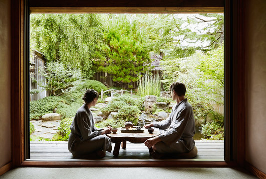 Couple looking at view and relaxing while drinking tea at Japanese Spa