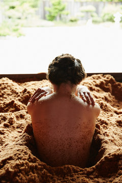 Woman soaking in fermented Japanese cedar enzyme bath at spa