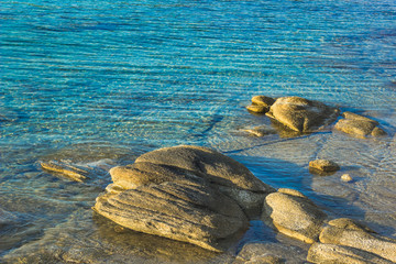 calm and peaceful natural scenic landscape background of lake waterfront with shallow water and stones on bottom 