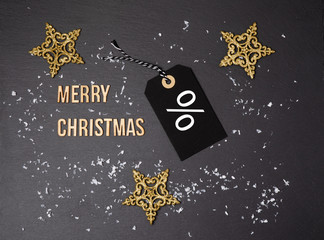 Fototapeta na wymiar Merry Christmas black background and price label. Black Friday. Sales concept. Copy space. Black paper label against a dark grey background. Black Friday shopping sale concept.