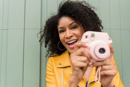 Woman Taking Photo With Pink Polaroid Camera