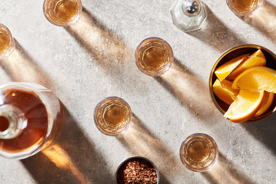 Several shots of golden alcoholic drink.