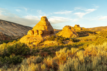 Eroded sandstone pyramid and domes glowing in the soft sunset light, Elephant Toes Butte, Dinosaurs...