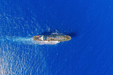 Obraz premium Oil chemical tanker sails blue sea. Aerial top view