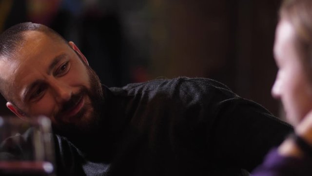 Close-up portrait of annoying male touching hair, shoulder, hugging outraged woman sitting at bar counter. Unresolved female applying skill of self defense techniques to neutralizing man