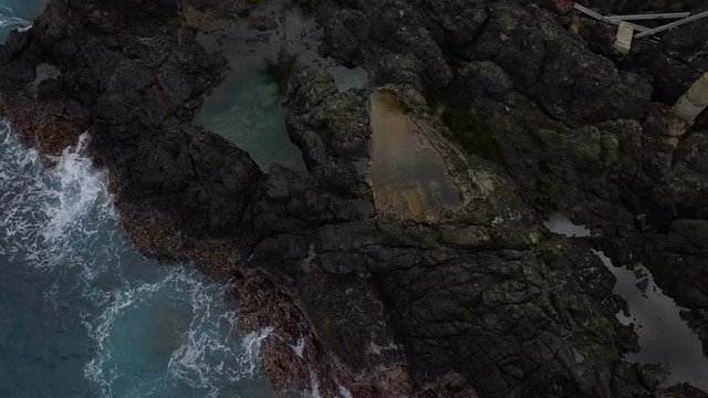 Aerial view of big footprint in seashore rocks