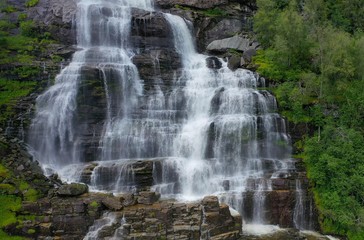 Tvindefossen (also written Tvinnefossen; also called Trollafossen) is a waterfall near Voss, Norway. It is 12 km from Voss on the road to FlÃ¥m.