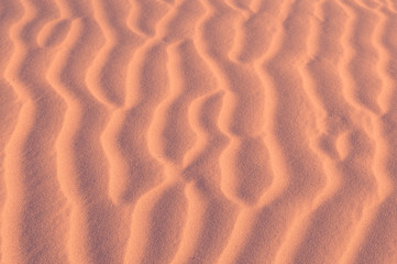 Sand texture background. Pink tint.