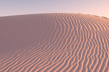 Sand texture background. Pink tint.