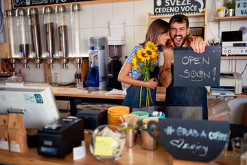 man and woman owner with open sign..