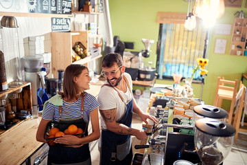 small business owner smiling at workplace with employee..