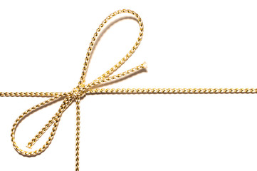 Golden satin rope with knotted bow gift ribbon wrap for Christmas present with intricate shine...