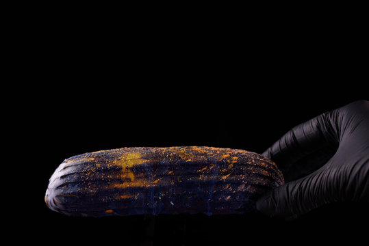 Beautiful bright eclair with blets on a dark background.
