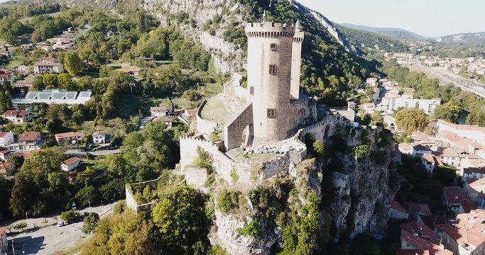 Aerial view of impressive medieval castle on rocky outcrop in French commune of Foix