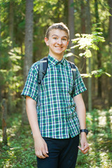 Fototapeta premium teenager boy walking in the forest alone in the summer day