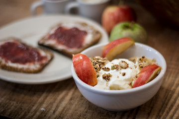  Bowl of homemade yogurt with cereals and cut apple