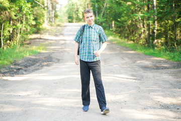 Fototapeta premium teenager boy walking in the forest alone in the summer day