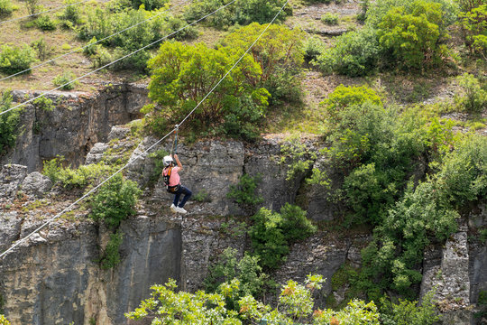 Tourist sliding on a zip line in Incekaya Canyon just near Kristal Cam Teras, Safranbolu Karabuk, Turkey