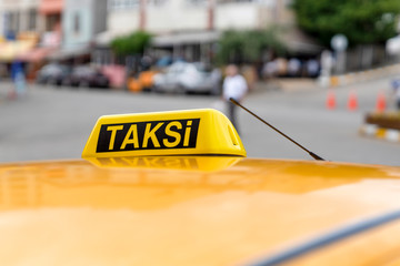 Taxi sign on the roof of taxi. Waiting taxi on the street. Yellow cab in Turkey.