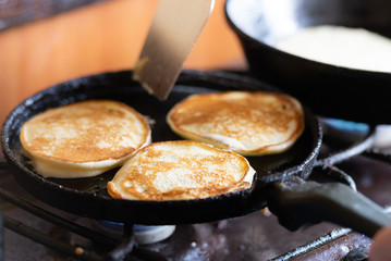 Pancakes in the pan. Homemade pancakes for breakfast in a cast iron pan.