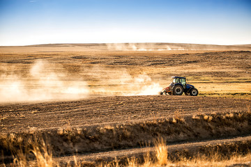 A farmer in tractor on arid land.Traditional farming practices in Turkey