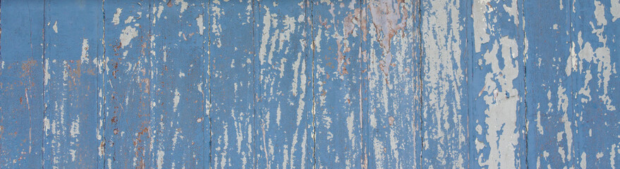 Blue painted wooden wall plank  perpendicular to the frame as simple peeling paint timber old...