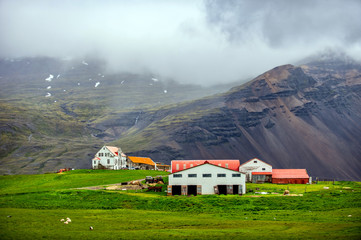 A farm is in the middle of a beautiful valley in Iceland.