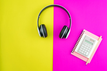 Headphone with Business paper note,pencil and business objects on colorful paper background