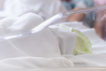 Obraz na płótnie Canvas Selective focus of newborn baby boy and mother sleeping in a hospital