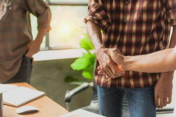 Business handshake executives to congratulate the join business agreement.concept for architect or engineer contract for architectural project.Stressed with partner and engineering tools on workplace