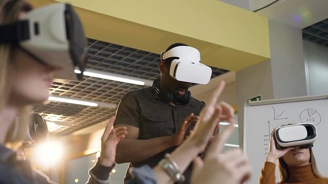 Concentrated business man in virtual reality VR glasses working in the office.