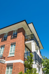 The corner of brand new apartment building on blue sky background