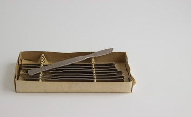 set of scalpels in a box on a light background