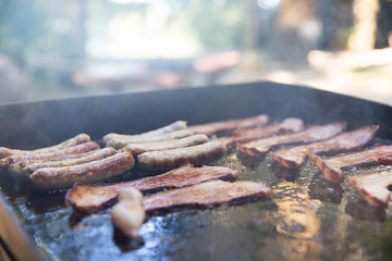 Breakfast cooking on a camp grill outside