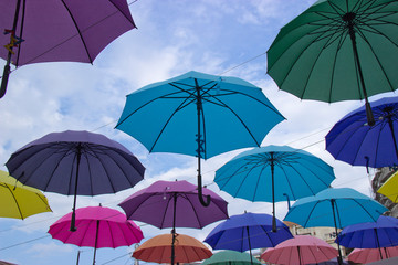 Obraz na płótnie Canvas Colorful umbrellas background. Colorful umbrellas in the sky. Street decoration.