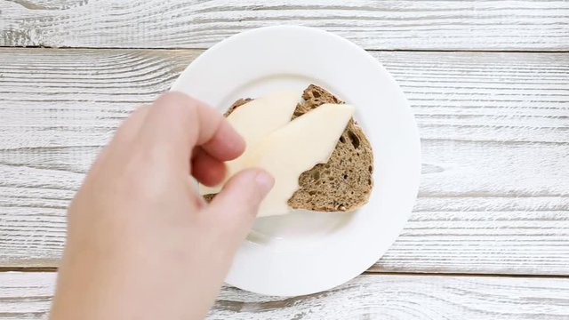 Chef hand making sandwich with pear and dorblu cheese for breakfast and lunch. Top view, close up