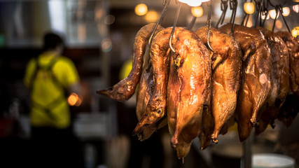 Close-up of a roasted duck meat hanging in asian restaurant.
