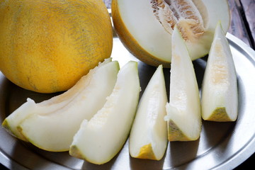 sliced pieces of melon on a metal plate