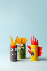 paper toy ghost, bat, monsters for Halloween party. Easy crafts for kids on blue background, copy...