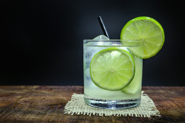 Lemon Fruit Lime Caipirinha of Brazil on grey vintage, Brazilian traditional drink, isolated with space for text.