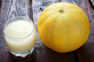 melon smoothie on a dark wooden table