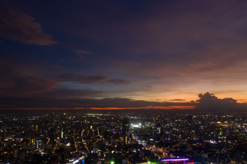 Naklejka premium Top View of Building in a City - Aerial view Skyscrapers flying by drone of Phnom Penh city with riverside , Palace and small island in sunset