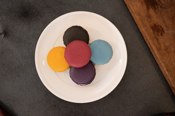 The top corner of the focus selection The macaroon on the table, black cloth, with dust pattern and space for text entry