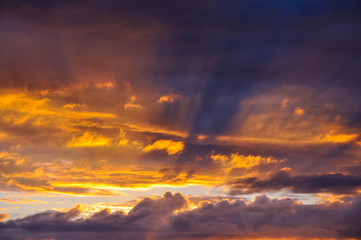 Sun rays breaking through the dark clouds at sunset. Hope, prayer, God's mercy and grace. Beautiful spectacular conceptual meditation background. Sky, purple, blue