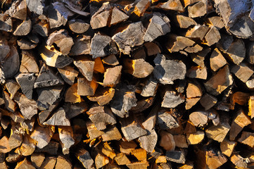 Abstract photo of a pile of natural uneven wooden logs background. Concepts: Background, pattern, eco