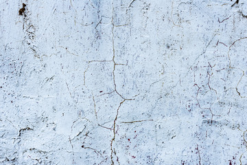 Texture of a concrete wall with cracks and scratches which can be used as a background