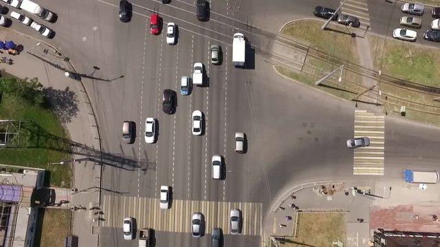 car traffic on road in modern town in summer day, aerial shot