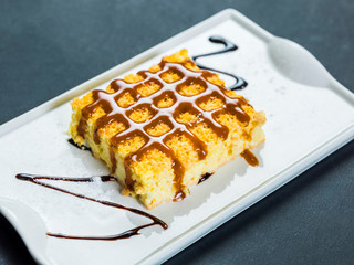 Tres leches dessert on plate over black table